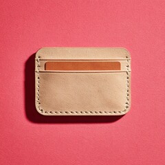 A rose gold glitter card holder with a copper colored insert lies on a red textured surface, casting a soft shadow.