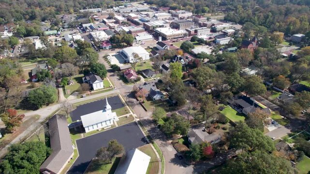 Aerial flight over the city of Jefferson in East Texas. Camera flies over buildings and businesses.