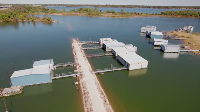 Aerial video of several boat houses on Lake Lewisville near the Copperas Branch Park in Texas