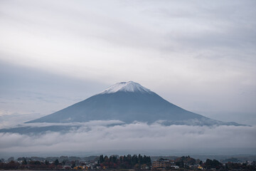 Lake Kawaguchi, Fujikawaguchiko, Minamitsuru District, Yamanashi, Japan, Mount Fuji with snow cap and clouds over rural landscape in Japan