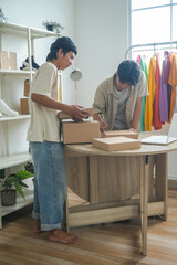 Two Men Diligently Package Orders in Bright, Modern Workspace
