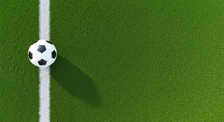 A top-down view of a classic black and white soccer ball resting on the white line of a vibrant green grass field.