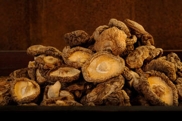 dried shiitake mushrooms on wooden background