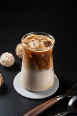 Refreshing iced latte showing beautiful layers of dark coffee and milk