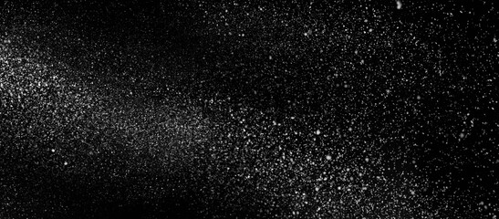 Freezing falling particles or stardust in air on black background for overlay blending mode. Stopping the movement of white powder on a dark background, selective focus, wide banner