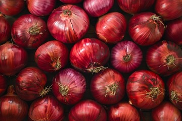Close up of numerous red onions creating a vibrant, textured backdrop, emphasizing the freshness and quality of the produce