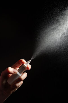 A hand holds a nasal spray, illustrating the use of drug treatments for rhinitis. This image highlights the reliance on vasoconstrictor drops for managing symptoms in respiratory diseases.