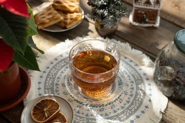 Christmas tea party. Cup of warm tea on rustic table