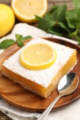 Tasty lemon bar with mint and fresh fruits on table, closeup