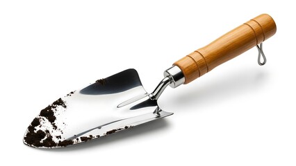 Fototapeta premium Gardening trowel with soil, perfect for planting flowers and maintaining gardens effectively