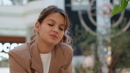 selfassured female in casual attire, young woman exuding confidence while shopping in lively mall environment, selfpossessed female figure showcasing style and composure in vibrant public setting