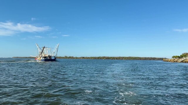 Commercial Fishing Trawler Navigates Broadwater Channel at Sunset