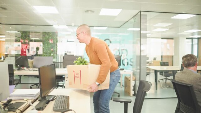 Employee leaving office with cardboard box