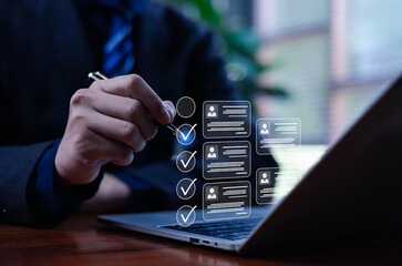 A business professional is working on a computer using a business performance appraisal on a laptop, completing an online survey and a digital form checklist, which showcases HR technology.