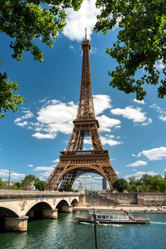 Paris France Eiffel Tower rising from banks of Seine River waterfront
