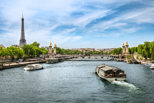 Paris France boats move along Seine River on Left Bank