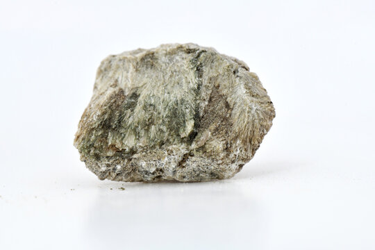 rough specimen of Colemanite mineral (hydrated calcium borate), displaying fibrous and crystalline structure, isolated on a clean white background.