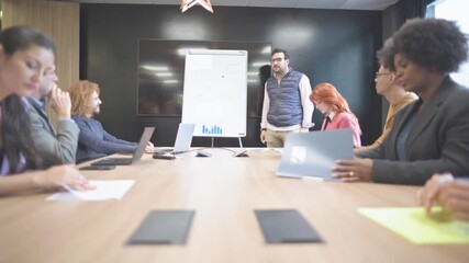 Diverse team applauding speaker after business presentation in modern office - Powered by Adobe
