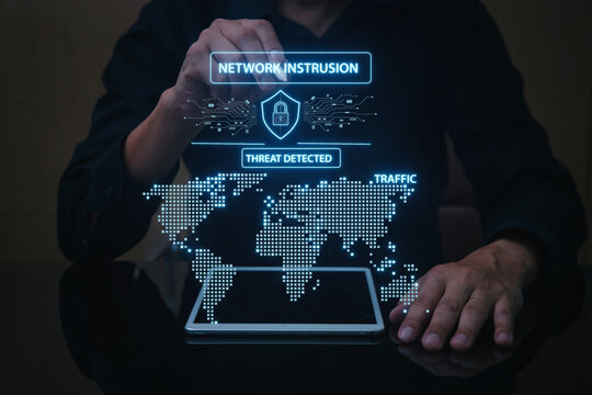 Focused man analyzes network traffic for cyber intrusion threat on futuristic hologram technology display - Powered by Adobe