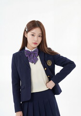 Studio portrait model photo of young Asian Korean schoolgirl posing in school uniform on white background.