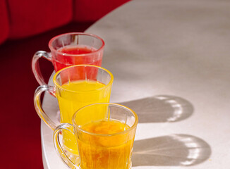 Brightly colored drinks on a table in a cozy setting during afternoon