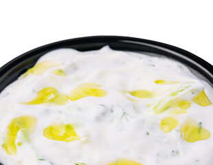 Creamy yogurt dip with olive oil and herbs ready for serving at dinner