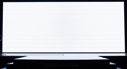 Bright White Screen and Stage in a Dark Room.