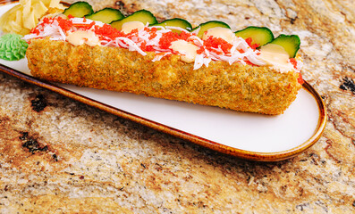 Delicious sushi roll with cucumber and spicy mayo on a platter