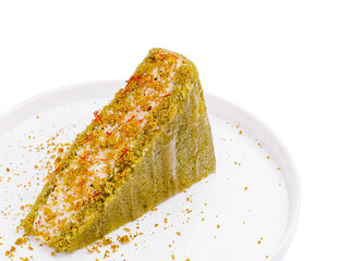 Delicious slice of pistachio cake with saffron on a clean plate