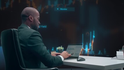 Black Male Stock Market Specialist Analyzes Trading Charts on Laptop in Fintech Office, Monitoring Price, Refining Investment Strategy, Candlestick Graphs and Digital Finance. 360 Degree Tracking Shot - Powered by Adobe