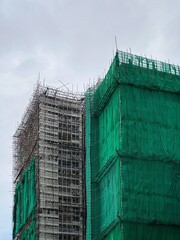 Bamboo scaffolding with building under construction with scaffolding, Hongkong Construction Safety, bamboo sticks