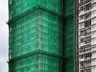 Bamboo scaffolding with building under construction with scaffolding, Hongkong Construction Safety, bamboo sticks