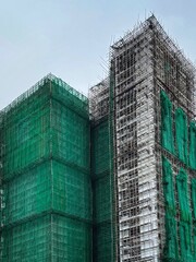 Bamboo scaffolding with building under construction with scaffolding, Hongkong Construction Safety, bamboo sticks