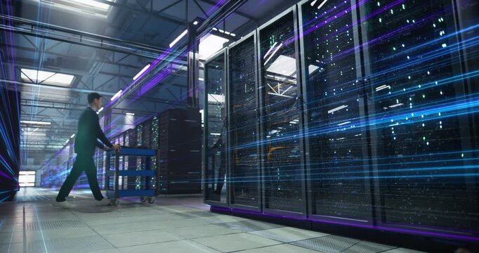 Asian Female and Male IT Specialists Walk in Data Center, Supervising Server Racks, Data Streams visualisation, Cybersecurity Control, and High Speed Digital Workflow Visualisation