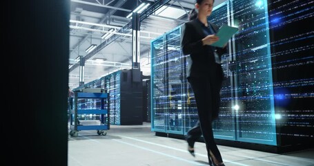 IT Manager Strides Through a Hyperscale Data Center, Inspecting Tablet Dashboards as Animated Light Lines of Digitization, Cloud Traffic, Server Performance, and Secure Network Operations - Powered by Adobe