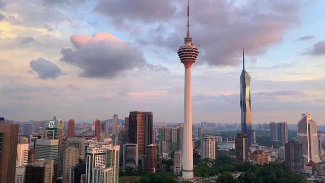 Kuala Lumpur, Malaysia, June 8, 2025: Sunset from an observation deck in Kuala Lumpur. Sunset sky illuminated by twilight, TV tower, and high-rise buildings from the air in the city center. 4K