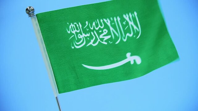 Saudi Arabia table flag on blue background
