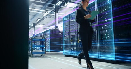 Female IT Manager Walks Through a High Tech Data Center, Auditing Servers on a Digital Tablet as Data Streams Race Along Racks, Visualizing Cloud Traffic, Big Data Processing, Cyber security Control - Powered by Adobe