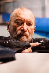 Portrait of senior free diver in wet suit looking at camera at poolside 