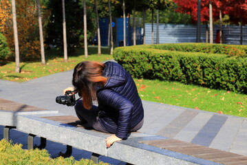 A female photographer, journalist, correspondent takes pictures on the street