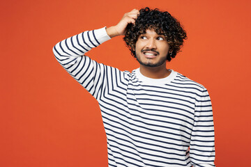 Young sad unhappy disappointed mistaken Indian man he wears striped sweatshirt casual clothes hold...