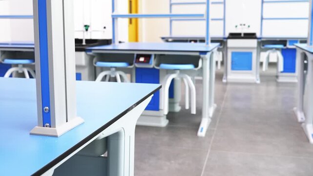 Modern empty science laboratory with blue desks of the school