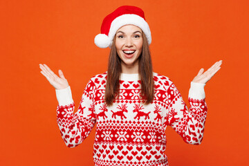 Merry shocked surprised excited young woman she wear red warm knitted Christmas sweater Santa hat...