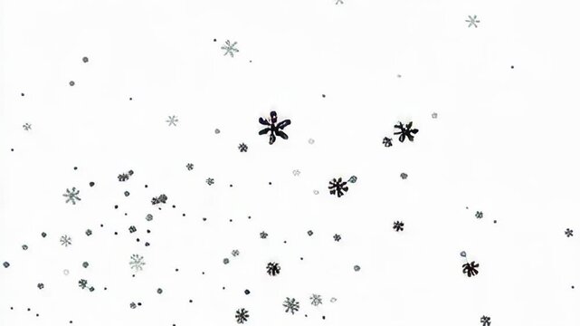 A collection of snowflakes falling against a bright white background, creating a winter scene.