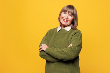 Elderly smiling happy cheerful blonde woman she wear green sweater casual clothes hold hands...