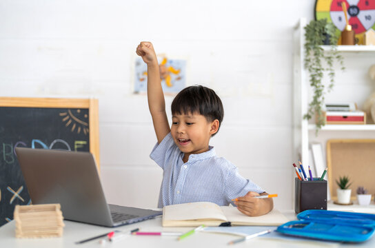 Asian boy using laptop with course online learning, distance education for kids, e-learning at home, child studying digital technology, interactive education platform, remote class tutorial