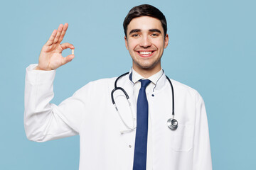 Young happy male doctor man wear white medical gown suit work in hospital clinic office hold in...