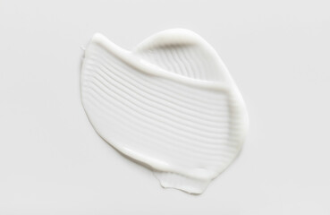 samples of cosmetic care products smear of cream  texture on a light background