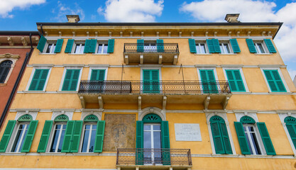 Verona, Italy. Traditional colorful building with balconies, shutter windows and multicolored walls in typical italian street	
