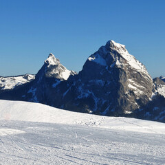 Ski slope in Stoos and peaks of the mountains Kleiner Mythen and Grosser Mythen, Switzerland.
